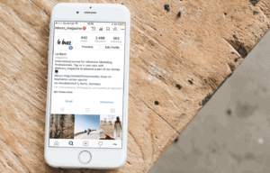 iPhone on table showing Instagram account page