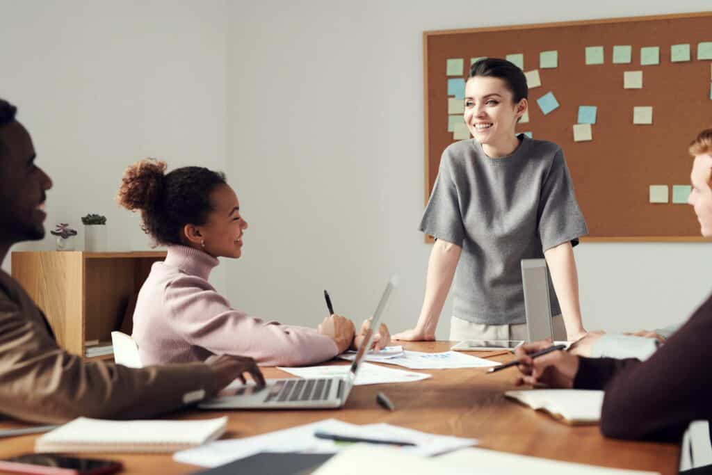 Four people at a desk in a meeting