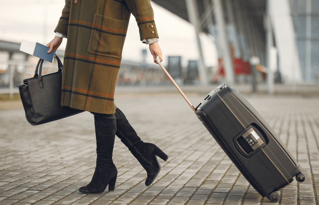 Woman at airport pulling suitcase
