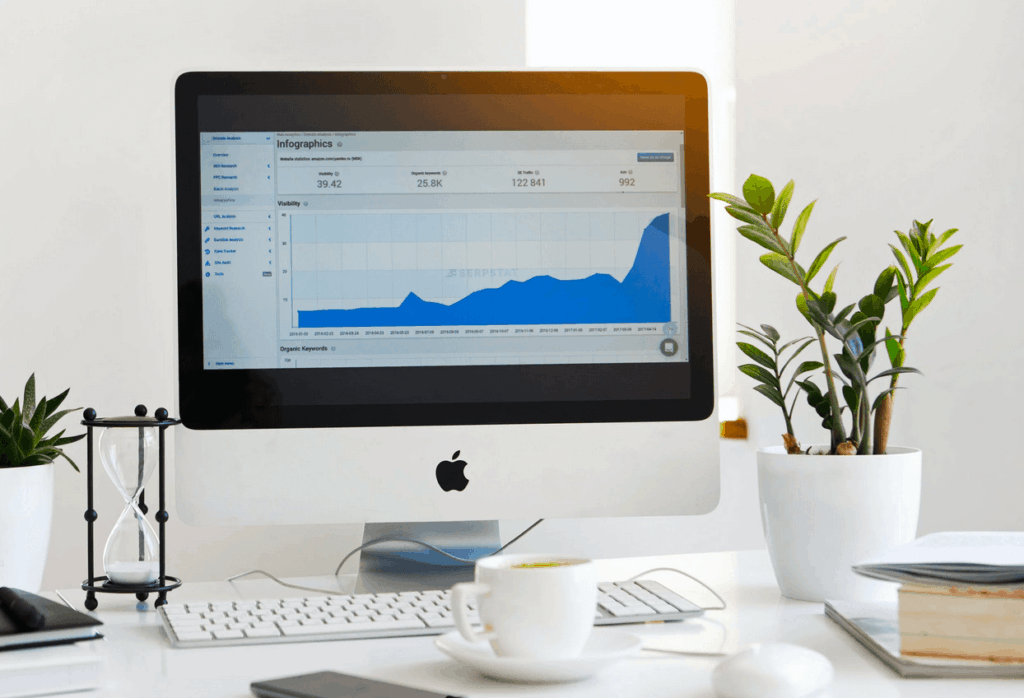 Desktop computer sitting on desk showing website analytics
