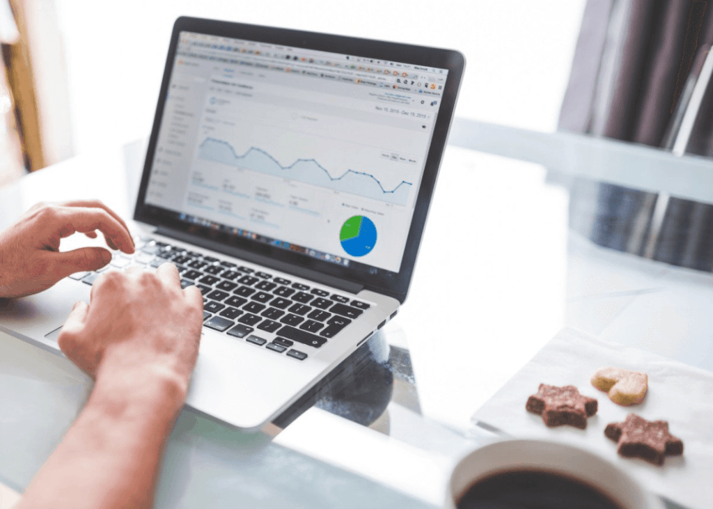 Person sitting at desk using laptop to view Google Analytics
