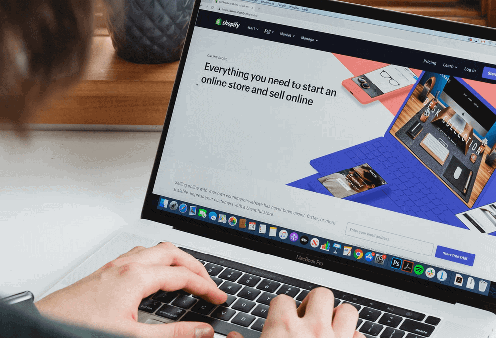 Person using laptop to edit ecommerce website on shopify