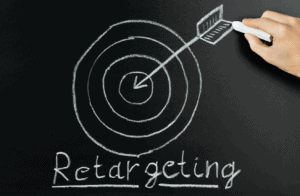 Chalk board showing someone drawing an arrow and target with the words retargeting