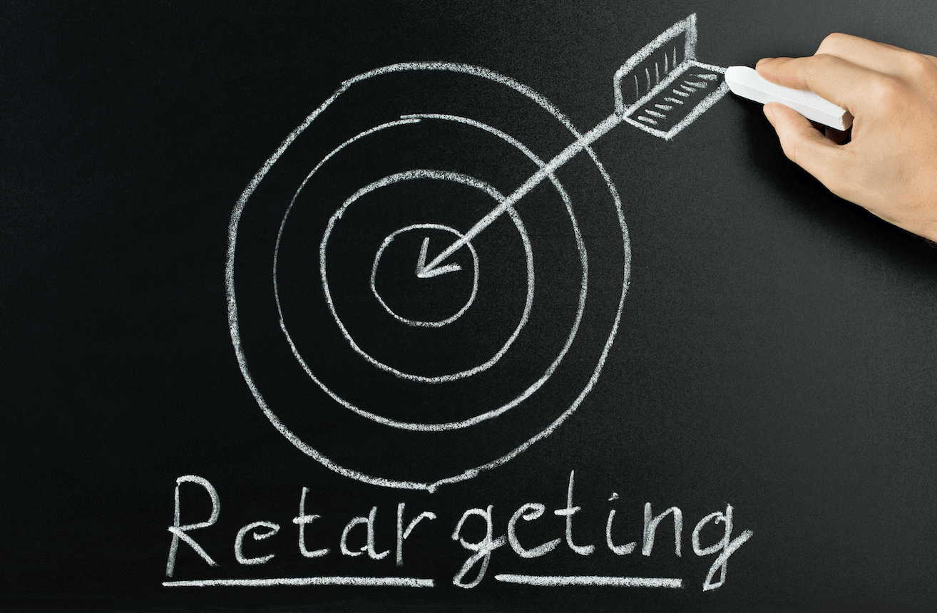 Chalk board showing someone drawing an arrow and target with the words retargeting
