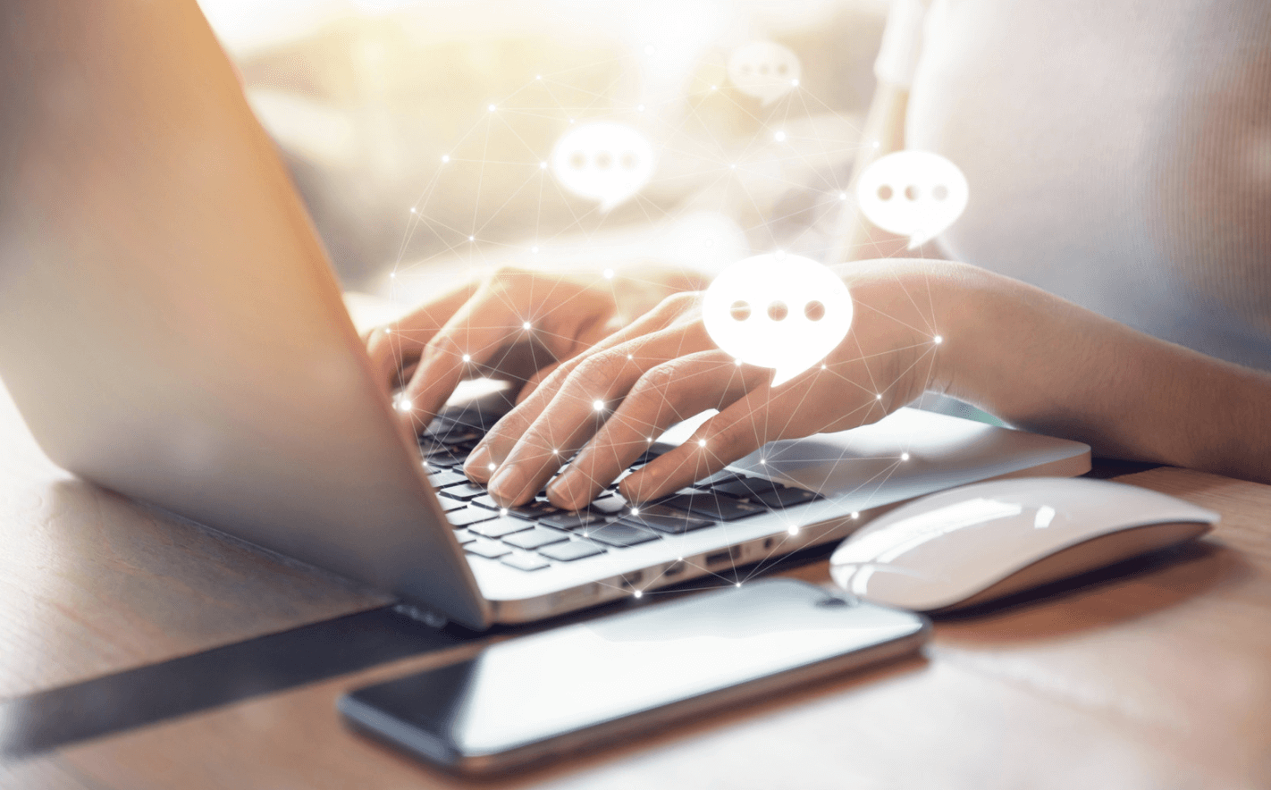 Person typing on laptop with chat symbol graphics