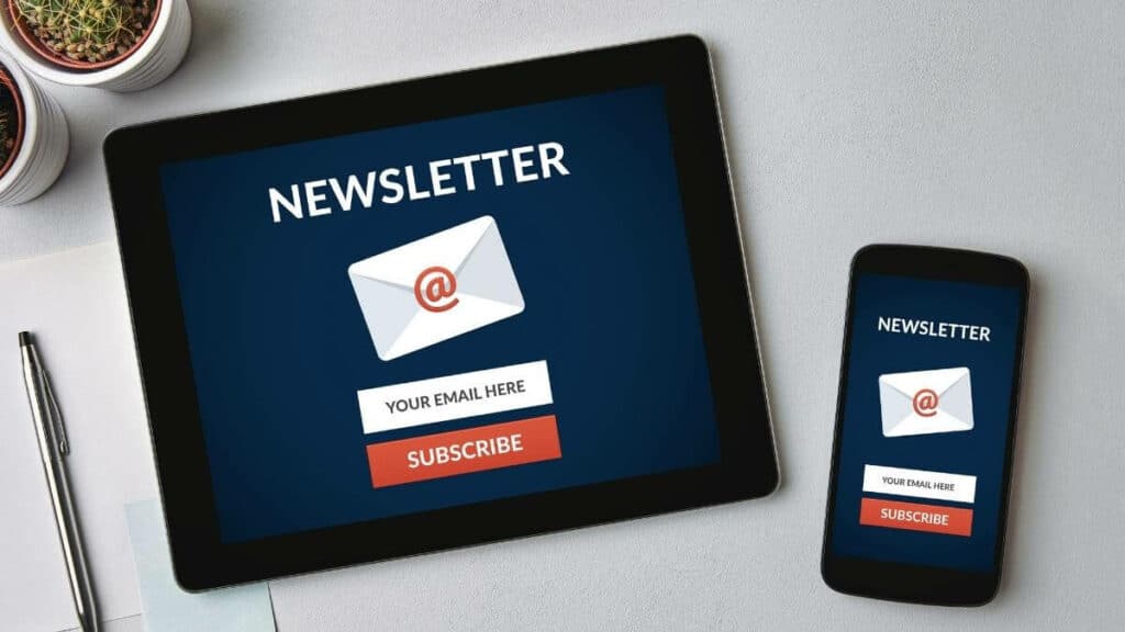 A tablet and a cellphone with an email newsletter graphic on them